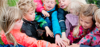 Children putting their hands on top of each other Photo: TrygFondens Centre for Child Research